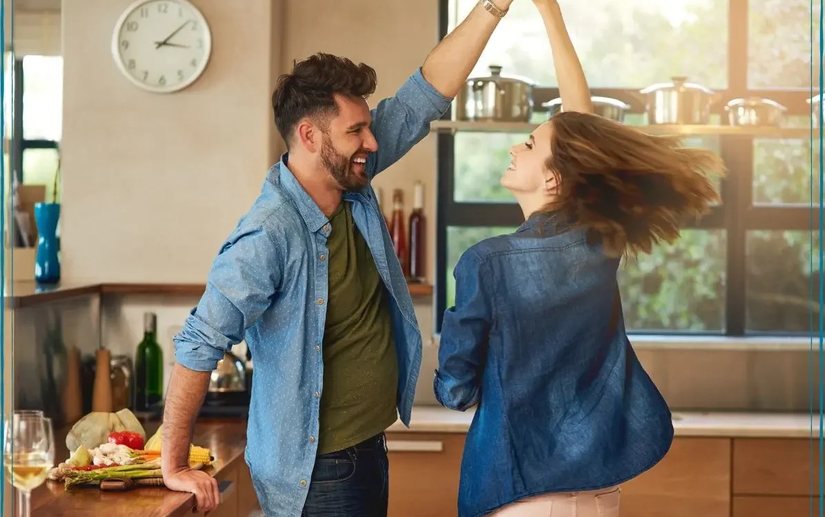 Couple dancing in the kitchen after ballroom lessons to boost your confidence