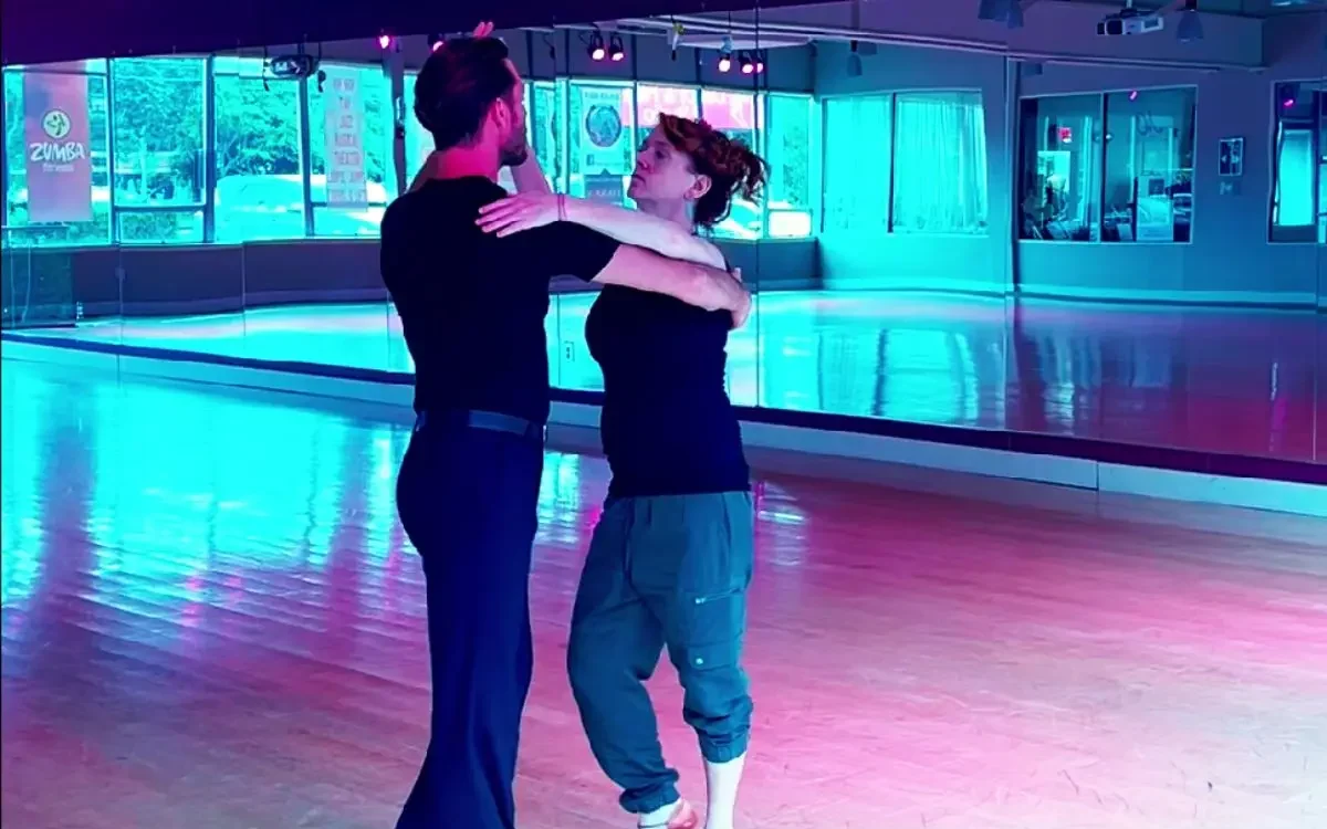 Instructor giving a private dance lesson to a student at a ballroom studio near me