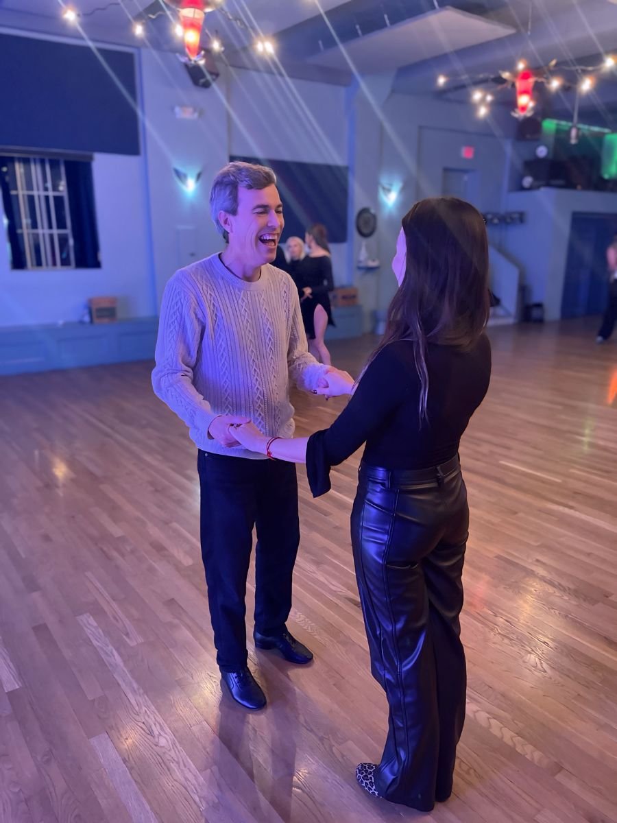 Happy student enjoying ballroom dance lesson at MI Fiesta Dance Studio near Boston.