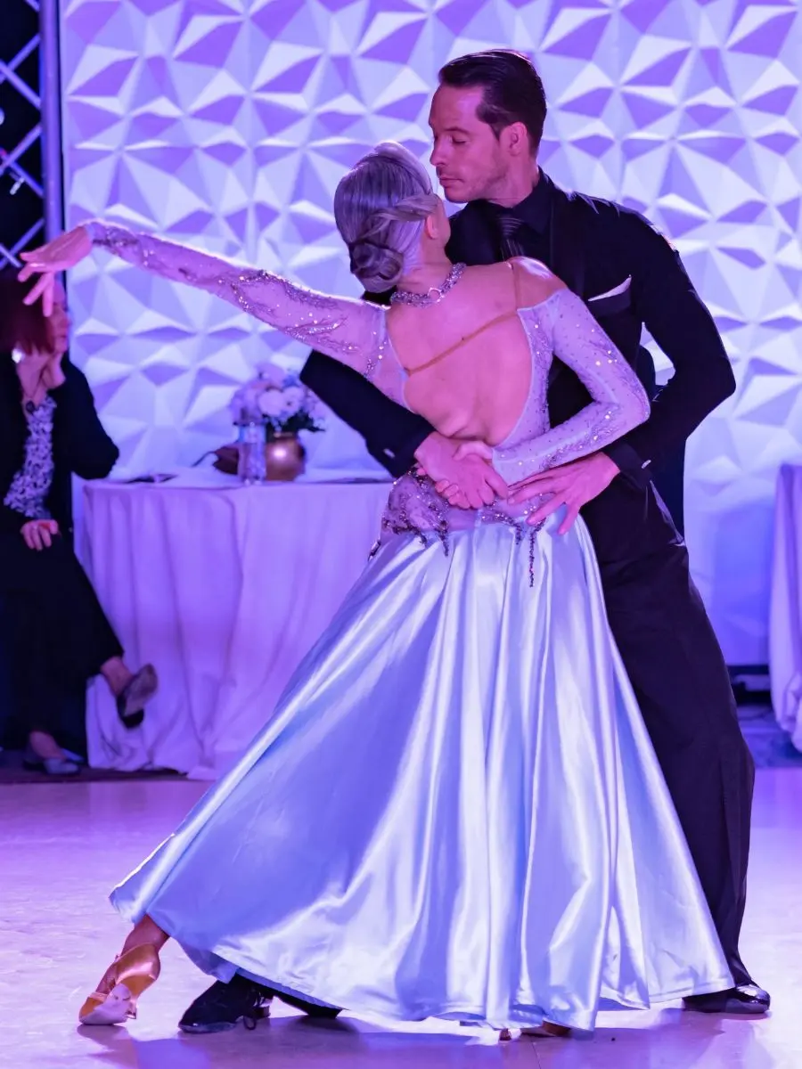 Ballroom dance studio performance showing an elegant couple dancing in formal attire, highlighting grace, style, and connection on the dance floor.