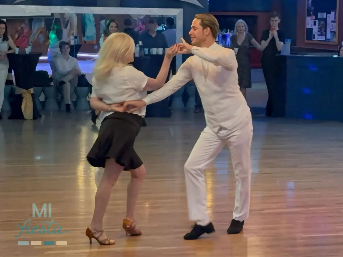 Irina and Imi performing a ballroom dance at the white party showcase at TK Dance Studio