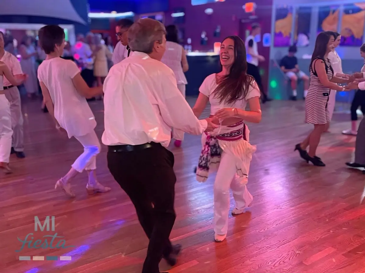 Ned and Mariam dancing Salsa at the White Party during a Pro-Am ballroom dance performance