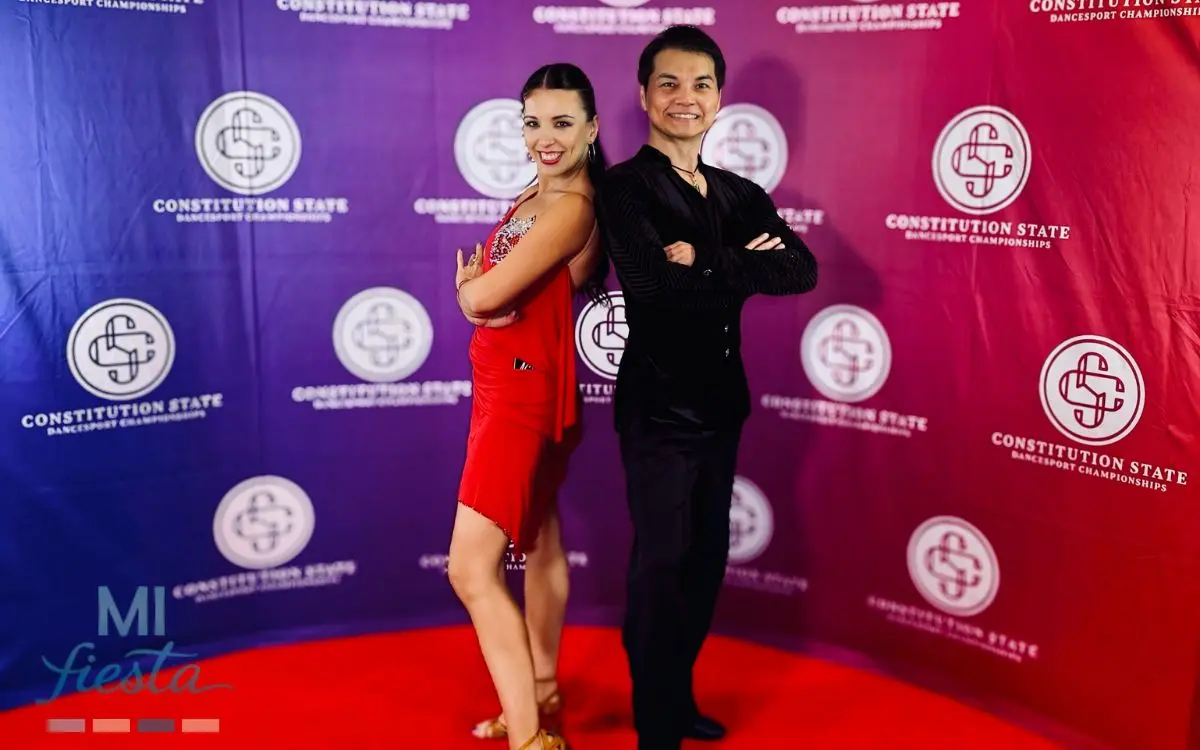 Stewart Hou and Mariam Izmaylova posing on the red carpet at the Constitution State Dancesport Championships 2025 in Stamford, Connecticut, representing MI Fiesta Dance Studio.